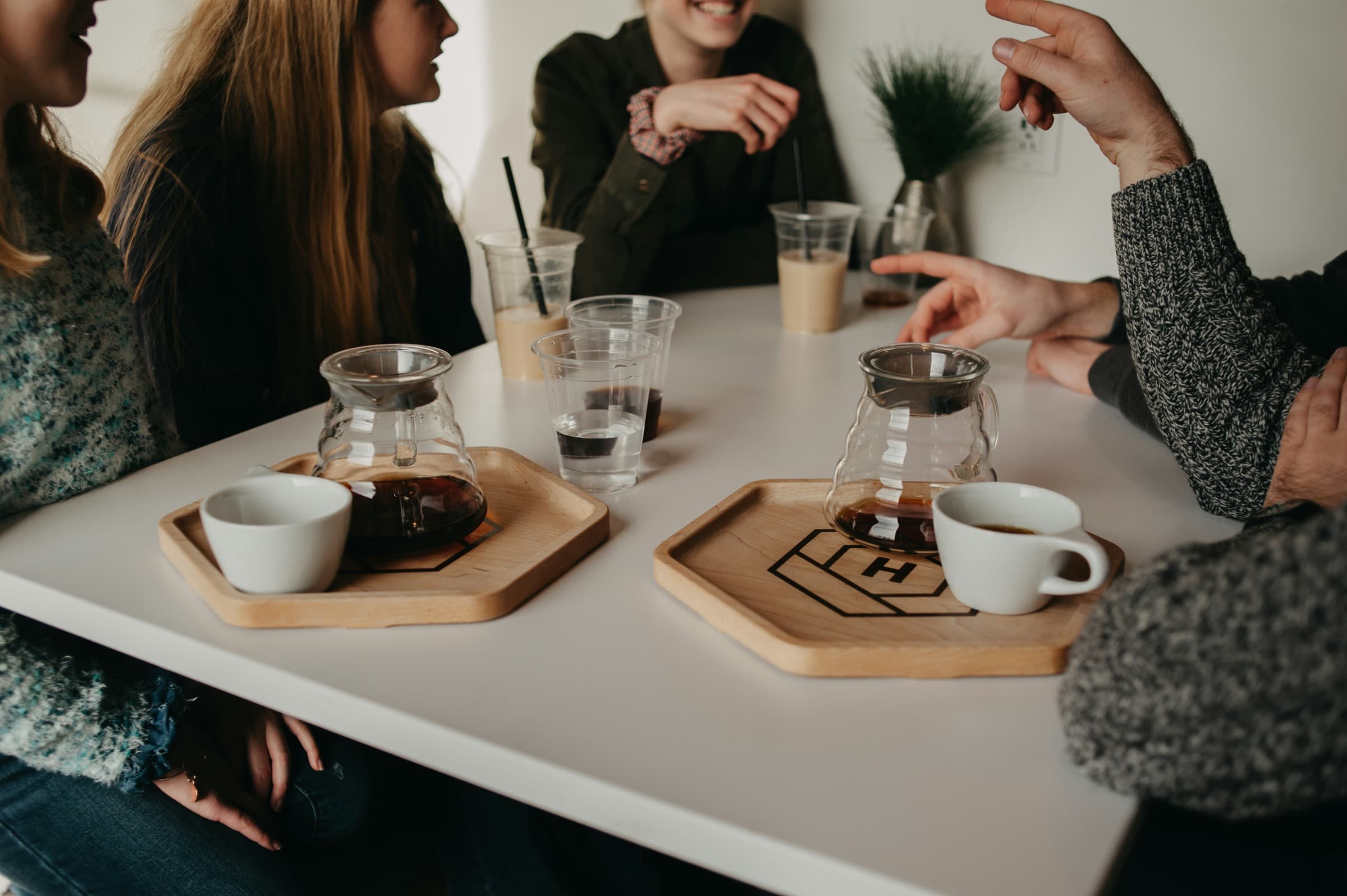 Friends talking around a table over coffee